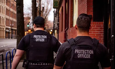 Two protection officers standing on a city street